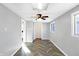 Bright living room featuring herringbone floors, modern ceiling fan, and abundant natural light from the window at 26 Highland Ave, Franklin, IN 46131