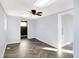 Well-lit living room with herringbone floors, ceiling fan, and access to other rooms at 26 Highland Ave, Franklin, IN 46131
