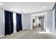 Bright living room featuring modern gray walls, plush carpet, and views into kitchen at 26 Highland Ave, Franklin, IN 46131