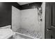 Modern tiled shower with contemporary fixtures and sleek design offers a luxurious bathing experience at 2610 Caroline Ave, Indianapolis, IN 46218