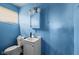 Compact bathroom with a classic white vanity, mirror, and toilet, providing essential functionality at 2610 Caroline Ave, Indianapolis, IN 46218
