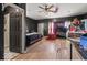 Spacious bedroom features wood-look flooring, an adjacent bath, a ceiling fan, and comfortable design elements at 2610 Caroline Ave, Indianapolis, IN 46218