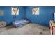 Simple bedroom with blue painted walls, carpet and a window, offering a peaceful and functional space at 2610 Caroline Ave, Indianapolis, IN 46218