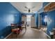 Dining area with wood-look floor and blue walls featuring a ceiling fan and a table with chairs in front of a window at 2610 Caroline Ave, Indianapolis, IN 46218
