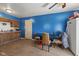 Dining area with blue walls and wood-look floor, showing the kitchen cabinets and a white refrigerator at 2610 Caroline Ave, Indianapolis, IN 46218