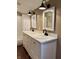 Bright bathroom with dual vanity, stylish mirrors, and a shower with white subway tile, blending functionality with style at 307 S Main St, Whitestown, IN 46075