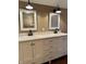 Well-appointed bathroom featuring a double vanity with marble countertop, framed mirrors, and modern black sconces at 307 S Main St, Whitestown, IN 46075