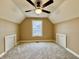 Cozy carpeted bedroom featuring a ceiling fan, built in storage, and a bright window at 307 S Main St, Whitestown, IN 46075