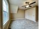 Bedroom with a ceiling fan, closet with sliding doors, and a bright window at 307 S Main St, Whitestown, IN 46075
