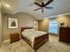 Warm bedroom featuring a wood frame bed, neutral walls, and a ceiling fan for added comfort at 307 S Main St, Whitestown, IN 46075