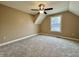 This carpeted bedroom has a ceiling fan, bright window, and cozy atmosphere at 307 S Main St, Whitestown, IN 46075