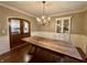 An open dining room featuring a wooden table beneath a modern chandelier at 307 S Main St, Whitestown, IN 46075