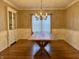 Formal dining room featuring a large wooden table and chandelier at 307 S Main St, Whitestown, IN 46075