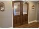 Elegant wood-framed glass doors with sleek black handles separate two rooms at 307 S Main St, Whitestown, IN 46075