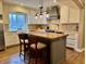 Modern kitchen featuring a center island with seating, stainless steel appliances, and pendant lighting at 307 S Main St, Whitestown, IN 46075