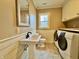 Functional laundry room with modern washer, dryer, stylish sink, and ample storage, maximizing space and convenience at 307 S Main St, Whitestown, IN 46075