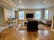 Open-concept living room with hardwood floors, large sectional sofa, and desk at 307 S Main St, Whitestown, IN 46075