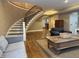 Cozy living area with an open floor plan, hardwood floors, and elegant staircase at 307 S Main St, Whitestown, IN 46075
