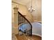 Elegant staircase with wooden rails and black wrought iron spindles at 307 S Main St, Whitestown, IN 46075