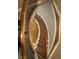 Overhead view of a winding staircase with dark wood handrail and detailed trim at 307 S Main St, Whitestown, IN 46075