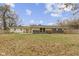 Large backyard features mature trees, a patio area, a playset, and wood fence at 3645 Glencairn Ln, Indianapolis, IN 46205