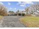 Ranch style home with long driveway, mature trees, neutral color palette, and attached garage at 3645 Glencairn Ln, Indianapolis, IN 46205