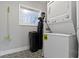 Efficient laundry room features a stacked washer and dryer, maximizing space and convenience at 3645 Glencairn Ln, Indianapolis, IN 46205