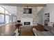 Open concept living room with fireplace, vaulted ceilings, and abundant natural light at 3645 Glencairn Ln, Indianapolis, IN 46205