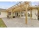 Beautiful covered patio with stained concrete, wooden pergola and exterior access to the home at 3645 Glencairn Ln, Indianapolis, IN 46205