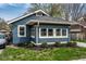 Charming bungalow featuring a blue exterior, well-maintained landscaping and a number over the front window at 3708 Rockville Rd, Indianapolis, IN 46222
