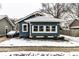 Charming blue home featuring a well-maintained lawn and a cozy covered porch at 3708 Rockville Rd, Indianapolis, IN 46222