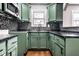 Updated kitchen featuring stylish cabinets, black countertops, and stainless steel appliances at 3708 Rockville Rd, Indianapolis, IN 46222