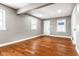 Spacious living room featuring hardwood floors, neutral walls, and ample natural light at 3708 Rockville Rd, Indianapolis, IN 46222
