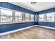 Inviting sunroom featuring new flooring and several windows for lots of sunlight at 3708 Rockville Rd, Indianapolis, IN 46222