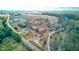 Wide aerial view of property featuring wooded area, fields, and proximity to a business district at 4018 S State Road 75, Coatesville, IN 46121