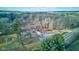 Beautiful aerial view of a wooded property with a cozy home and expansive outdoor space and a large grove of trees at 4018 S State Road 75, Coatesville, IN 46121
