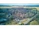 Stunning aerial view of the property surrounded by a lush forest and nature, with a charming house at 4018 S State Road 75, Coatesville, IN 46121