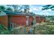 Backyard view of brick house with a fence, patio, and established landscaping at 4018 S State Road 75, Coatesville, IN 46121