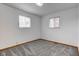 Bedroom features neutral carpet, white walls, wood baseboard trim and two windows with blinds at 4018 S State Road 75, Coatesville, IN 46121