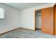 Bedroom with neutral carpet, white walls, window with blind and wooden closet door at 4018 S State Road 75, Coatesville, IN 46121