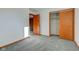 Bedroom showcasing soft carpet, a closet with sliding doors, and wood trim at 4018 S State Road 75, Coatesville, IN 46121