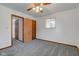 Cozy bedroom with a ceiling fan, a window with blinds, and neutral gray carpet at 4018 S State Road 75, Coatesville, IN 46121