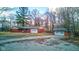 Features a single-story home with an attached and detached garage, surrounded by greenery at 4018 S State Road 75, Coatesville, IN 46121