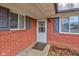 Charming front door with sidelight and brick surround offers an inviting welcome at 4018 S State Road 75, Coatesville, IN 46121