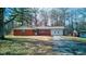 Cozy brick home featuring an attached garage and a well-manicured front lawn at 4018 S State Road 75, Coatesville, IN 46121