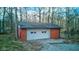 Exterior view of detached garage with a white door and brick siding at 4018 S State Road 75, Coatesville, IN 46121