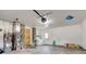 Cluttered garage featuring laundry area, mechanicals, concrete flooring and access door at 4018 S State Road 75, Coatesville, IN 46121