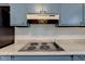 Kitchen with speckled countertops, electric stove, and blue cabinets at 4018 S State Road 75, Coatesville, IN 46121
