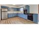 Bright kitchen with blue cabinets, modern appliances, and ample counter space at 4018 S State Road 75, Coatesville, IN 46121