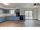 Well-lit kitchen featuring blue cabinets, laminate flooring, and modern appliances at 4018 S State Road 75, Coatesville, IN 46121